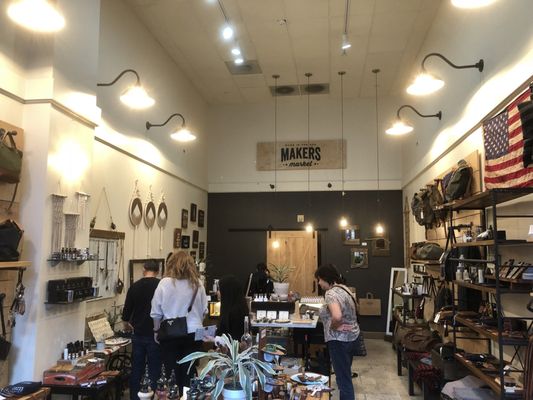 View inside Makers Market. Shopper in foreground looking at products